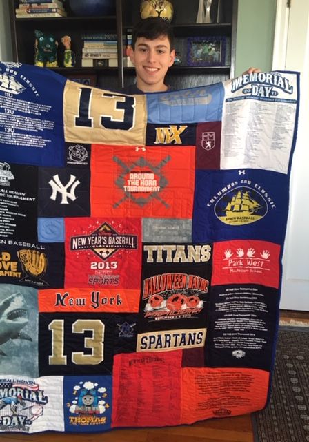 Young guy with T-shirt quilt by Too Cool T-shirt Quilts